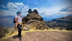 "Waqra Pukara Photos - Panoramic photo with a Tourist, admiring the landscape"